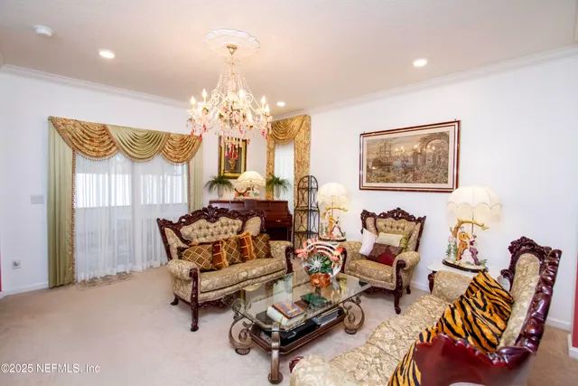 a living room with furniture and a chandelier