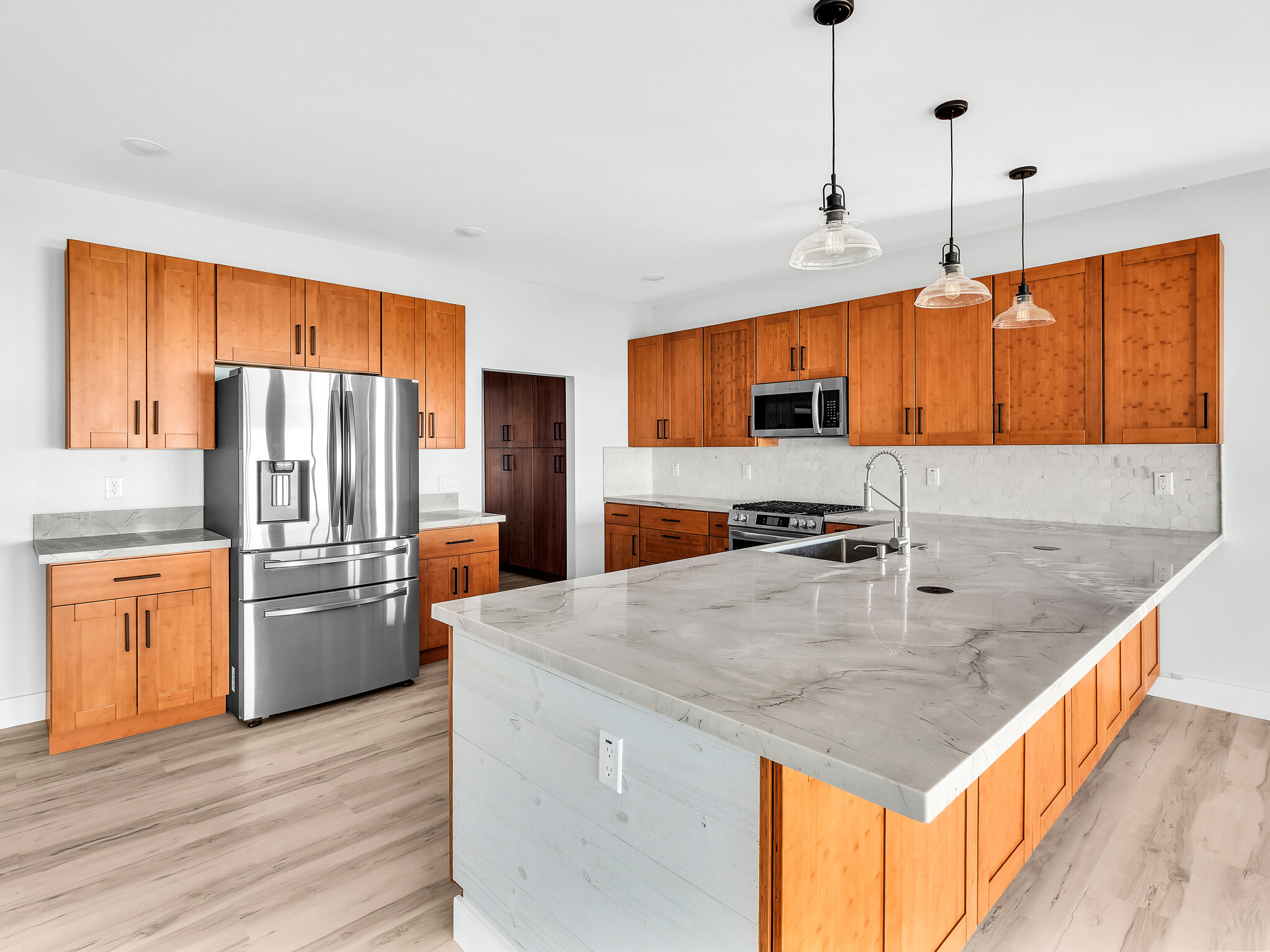 94-1549 Ha'Eha'e Street Naalehu, HI 96772 - Photo 12 of 30 a kitchen with stainless steel appliances granite countertop a sink a stove and refrigerator