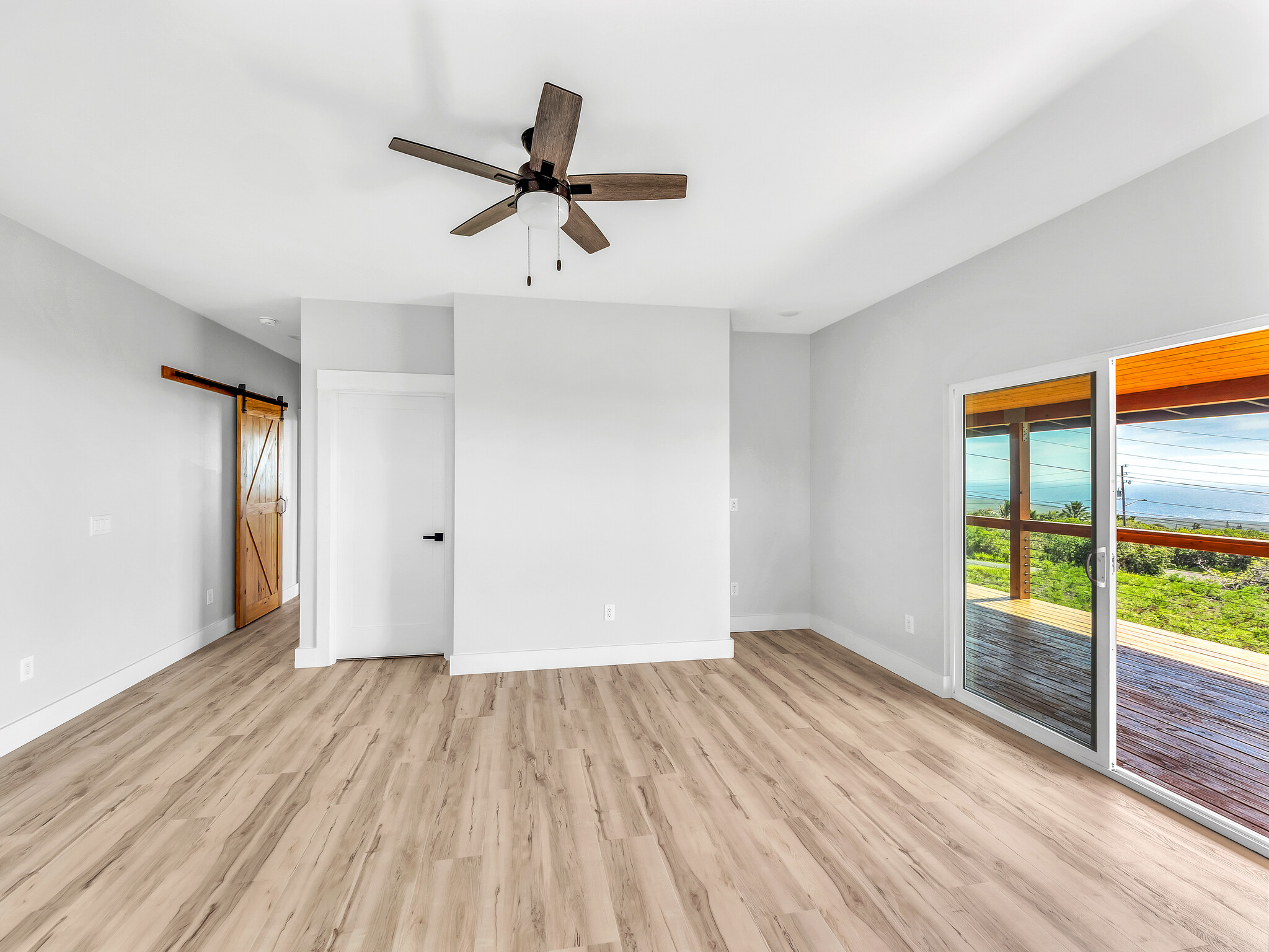 94-1549 Ha'Eha'e Street Naalehu, HI 96772 - Photo 15 of 30 a view of empty room with wooden floor and fan