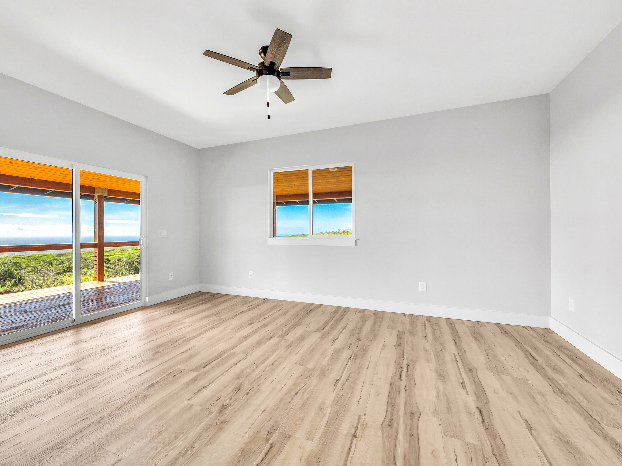 94-1549 Ha'Eha'e Street Naalehu, HI 96772 - Photo 16 of 30 wooden floor in an empty room with a window