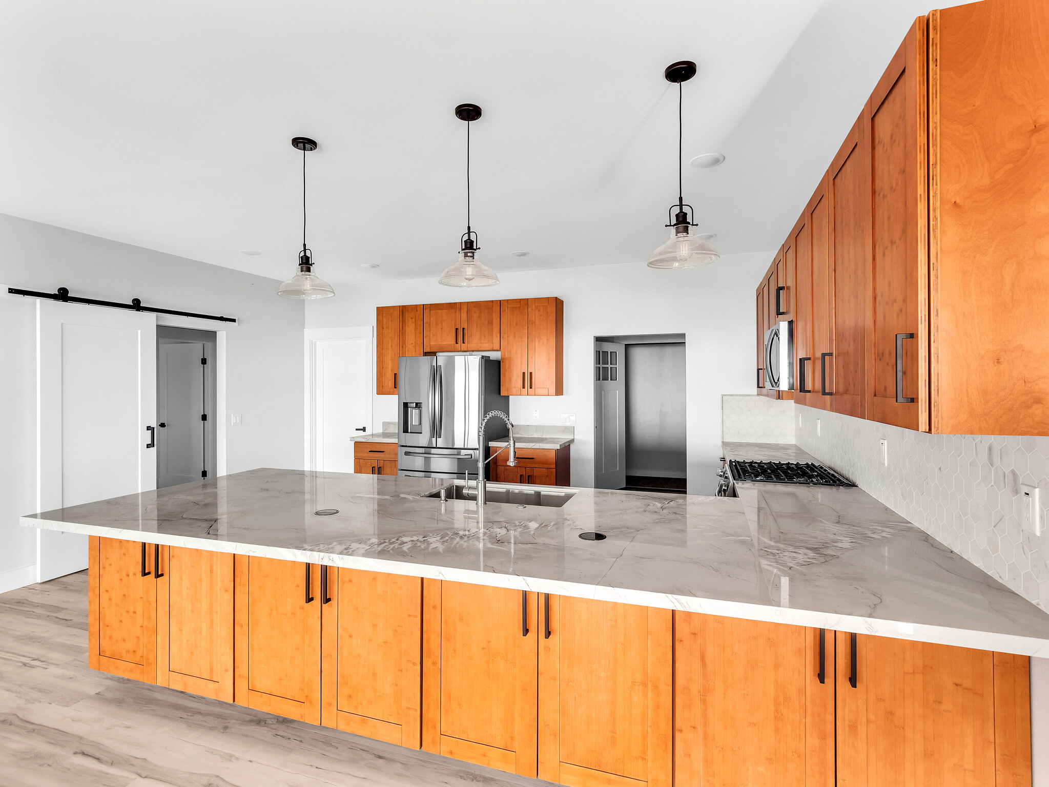 94-1549 Ha'Eha'e Street Naalehu, HI 96772 - Photo 2 of 30 a kitchen with stainless steel appliances granite countertop a sink and a refrigerator