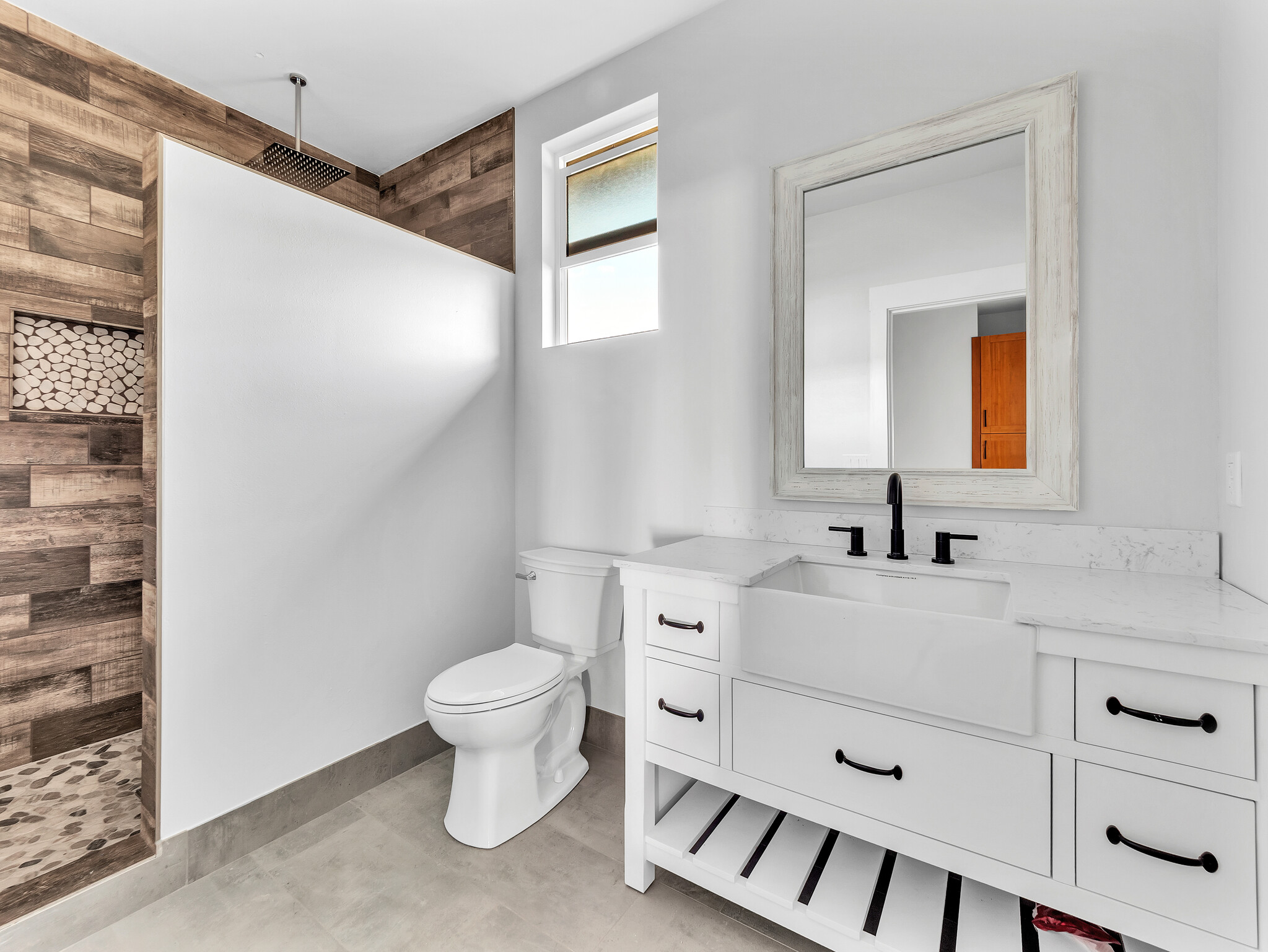 94-1549 Ha'Eha'e Street Naalehu, HI 96772 - Photo 21 of 30 a bathroom with a toilet sink and mirror