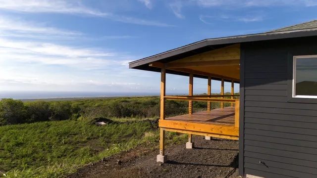 a backyard of a house with wooden floor outdoor seating yard and barbeque oven