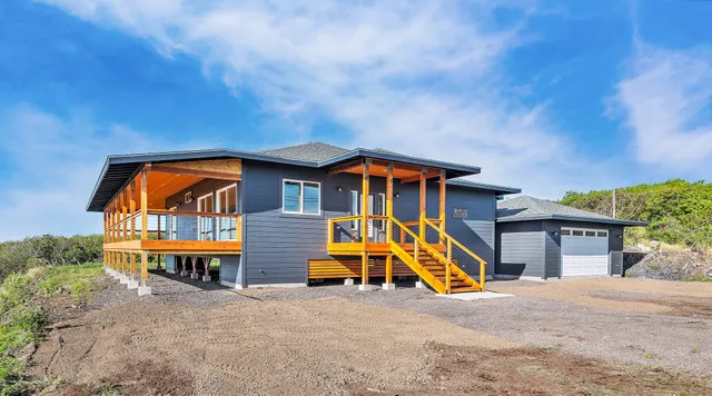 a backyard of a house with table and chairs