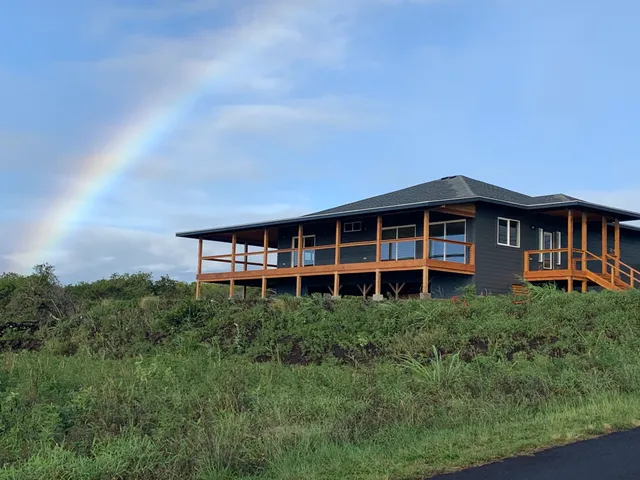 a view of a big yard with large trees