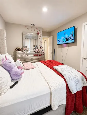 a bedroom with a bed and a chandelier