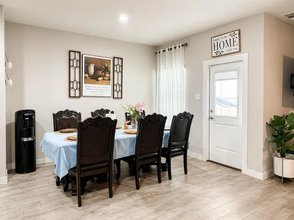 a view of a dining room with furniture and a potted plant