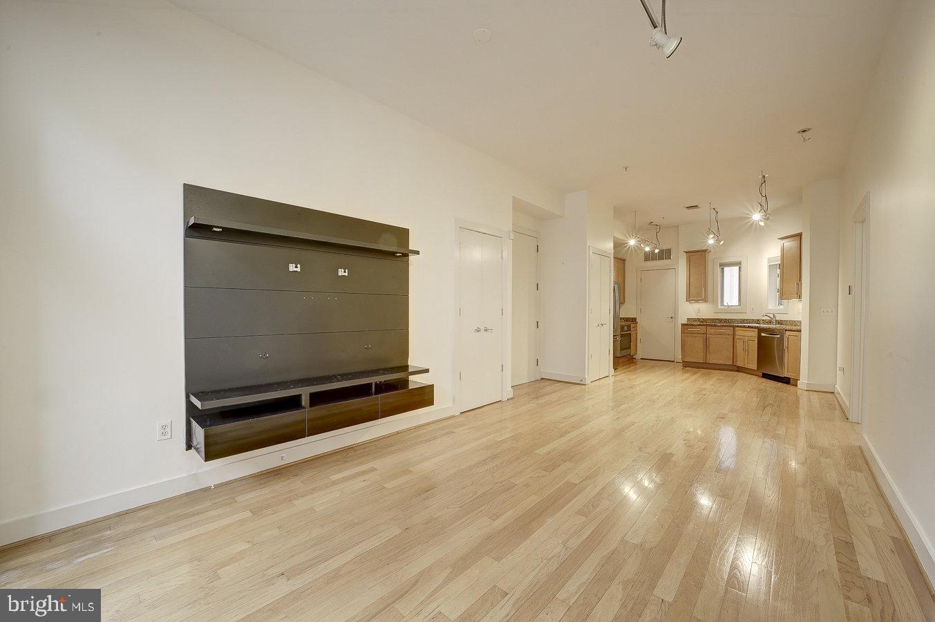2357 Champlain Street Northwest, Unit 201 Washington, DC 20009 - Photo 3 of 13 a view of an empty room with a kitchen