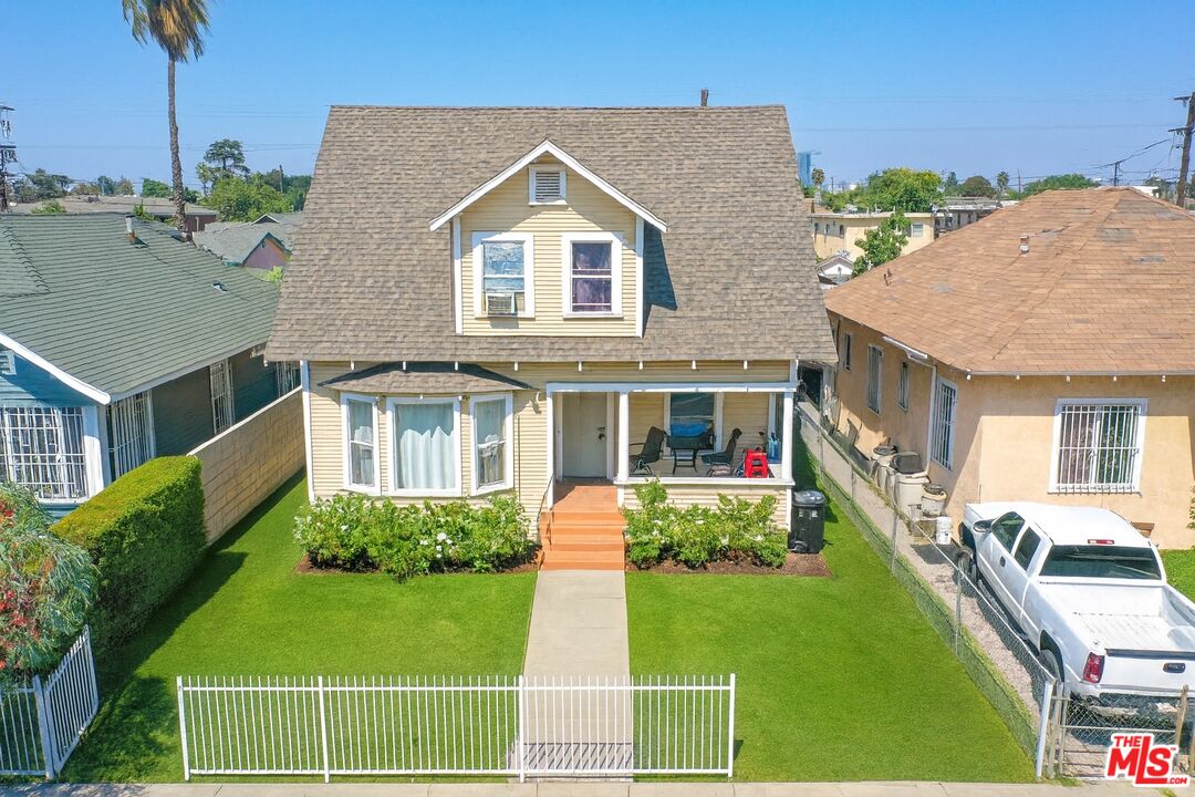 721 East 42nd Place Los Angeles, CA 90011 - Photo 1 of 8 a front view of a house with a yard table and chairs