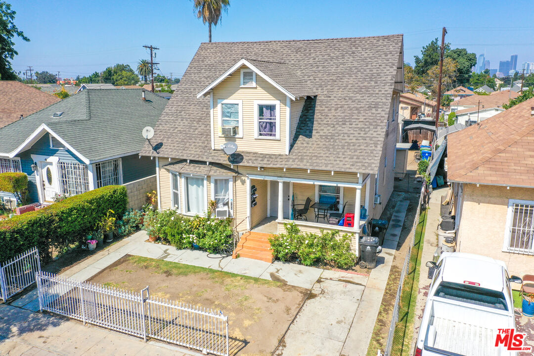 721 East 42nd Place Los Angeles, CA 90011 - Photo 3 of 8 a front view of a house with a garden