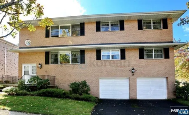 a view of a house with many windows and plants