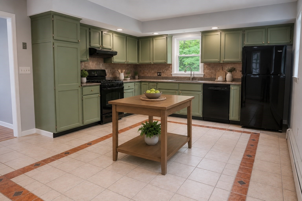 32 Dale Street Franklin, MA 02038 - Photo 4 of 11 a kitchen with stainless steel appliances a sink a stove a refrigerator cabinets and a dining table