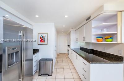 609 Ocean Drive, Unit 8G Key Biscayne, FL 33149 - Photo 13 of 44 a large kitchen with stainless steel appliances granite countertop a refrigerator and a sink