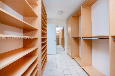 609 Ocean Drive, Unit 8G Key Biscayne, FL 33149 - Photo 18 of 44 a view of walk in closet with empty racks