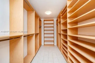 a view of walk in closet with empty racks