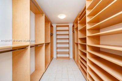 609 Ocean Drive, Unit 8G Key Biscayne, FL 33149 - Photo 19 of 44 a view of walk in closet with empty racks
