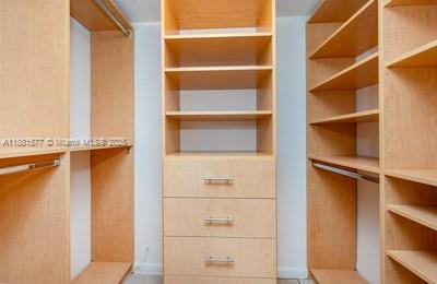 609 Ocean Drive, Unit 8G Key Biscayne, FL 33149 - Photo 20 of 44 a view of walk in closet with empty racks