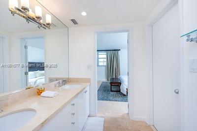 609 Ocean Drive, Unit 8G Key Biscayne, FL 33149 - Photo 21 of 44 a bathroom with a sink double vanity and a mirror