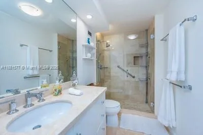 a bathroom with a sink shower and a mirror