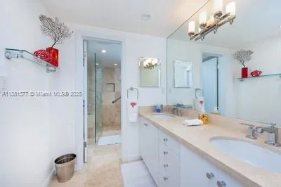 a bathroom with a sink vanity granite shower and a mirror