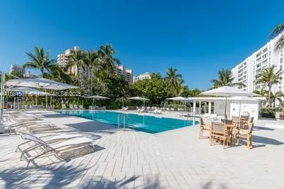 a view of a house with backyard porch and sitting area