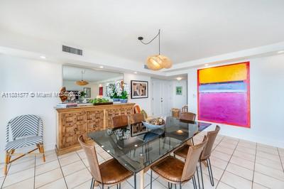 609 Ocean Drive, Unit 8G Key Biscayne, FL 33149 - Photo 6 of 44 a dining room with furniture and chandelier