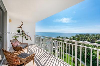 609 Ocean Drive, Unit 8G Key Biscayne, FL 33149 - Photo 8 of 44 a view of a chairs and table in patio