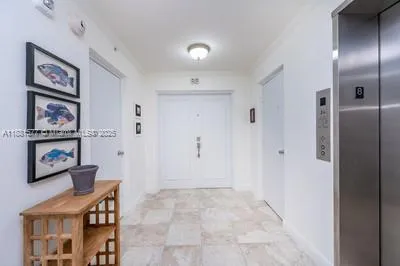 a view of a hallway with paintings on the wall