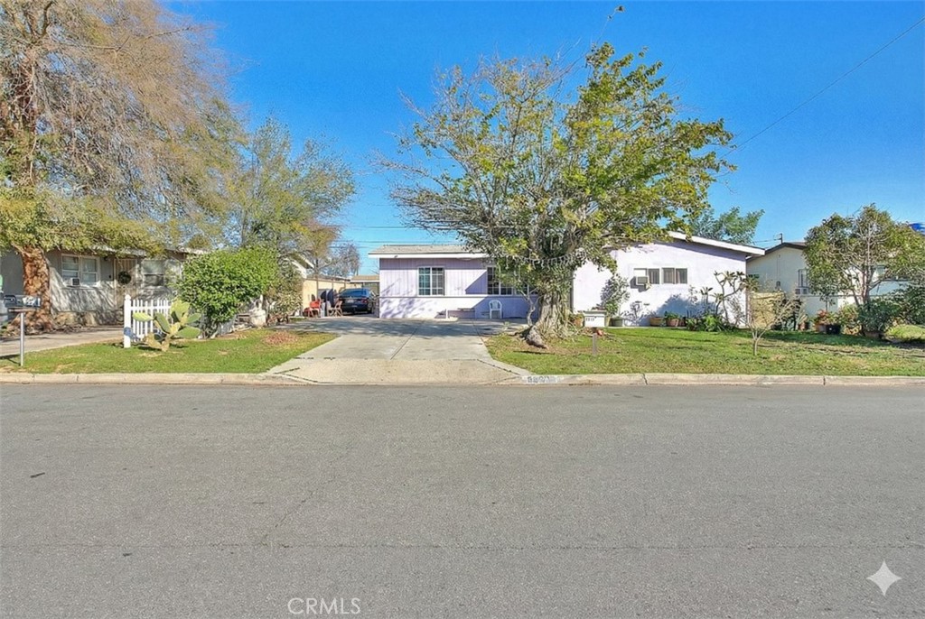 8651 Encinitas Avenue Fontana, CA 92335 - Photo 1 of 35 a view of house with yard and trees in the background