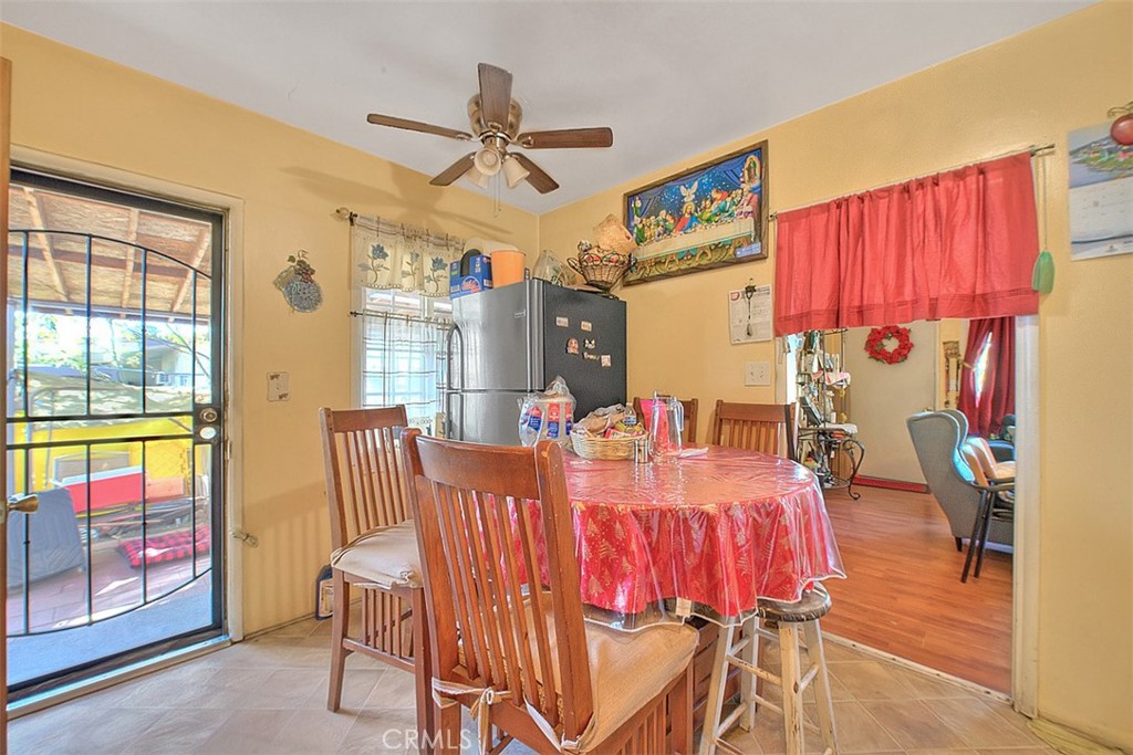 8651 Encinitas Avenue Fontana, CA 92335 - Photo 12 of 35 a view of a dining room with furniture window and wooden floor