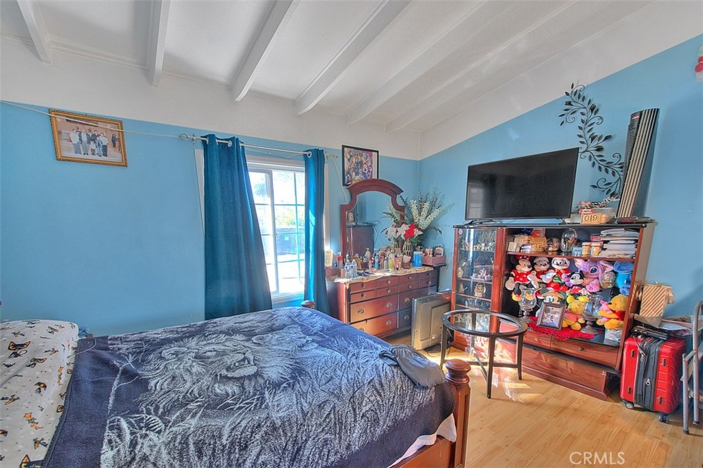 8651 Encinitas Avenue Fontana, CA 92335 - Photo 20 of 35 a bedroom with bed and wooden floor