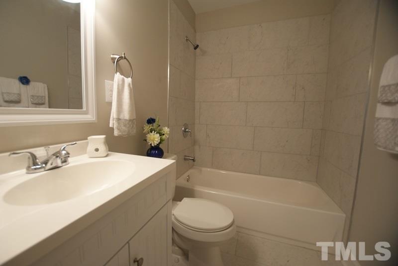 504 Cooper Road Raleigh, NC 27610 - Photo 11 of 21 a bathroom with a sink a toilet and shower