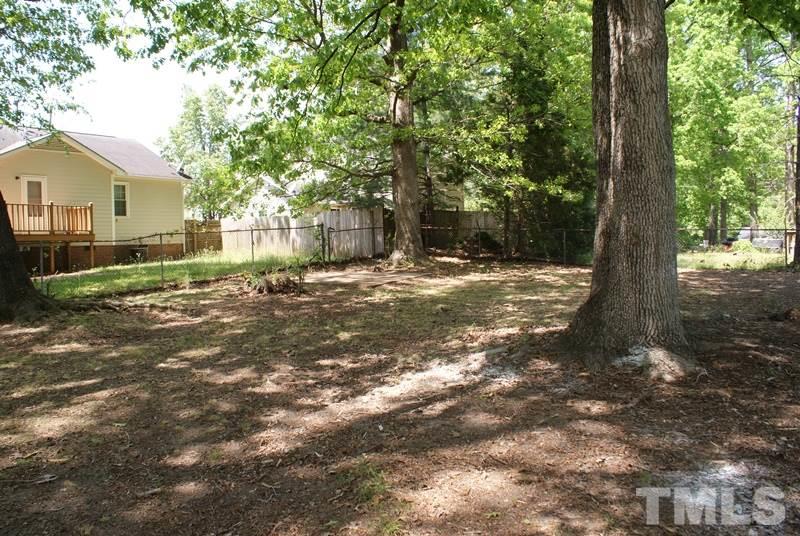 504 Cooper Road Raleigh, NC 27610 - Photo 20 of 21 a view of a yard with plants and large trees