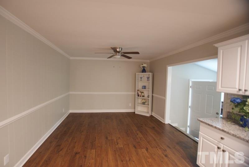 504 Cooper Road Raleigh, NC 27610 - Photo 7 of 21 a view of a room with wooden floors and ceiling fan
