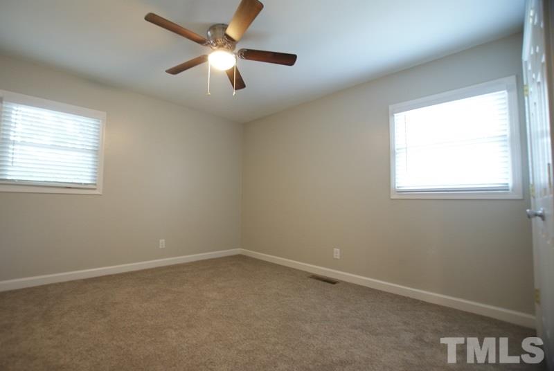 504 Cooper Road Raleigh, NC 27610 - Photo 9 of 21 an empty room with a window and a fan