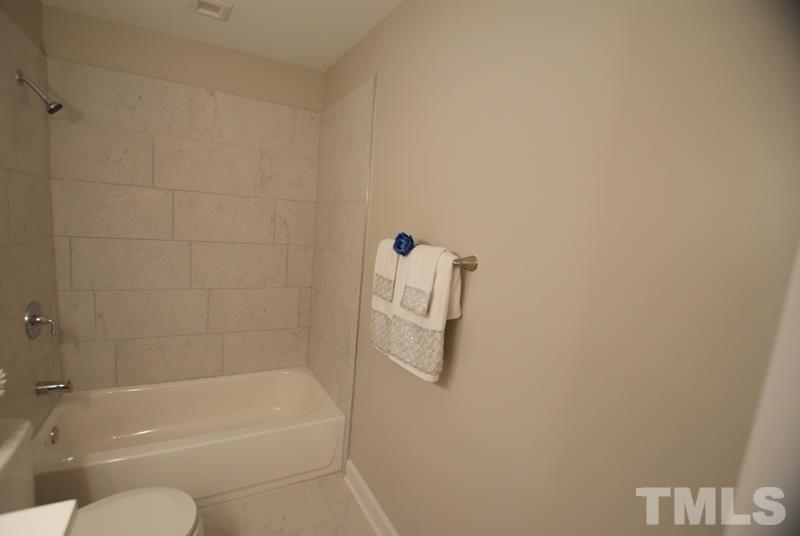 504 Cooper Road Raleigh, NC 27610 - Photo 10 of 21 a bathroom with a shower and bathtub