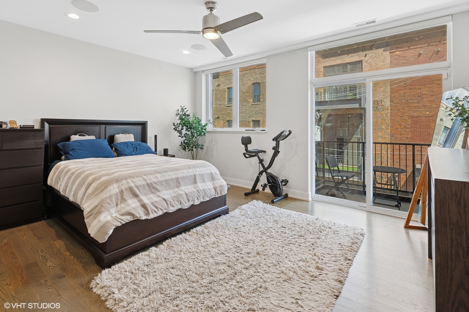 236 South Racine Avenue, Unit 304 Chicago, IL 60607 - Photo 11 of 19 a bedroom with a bed and wooden floor