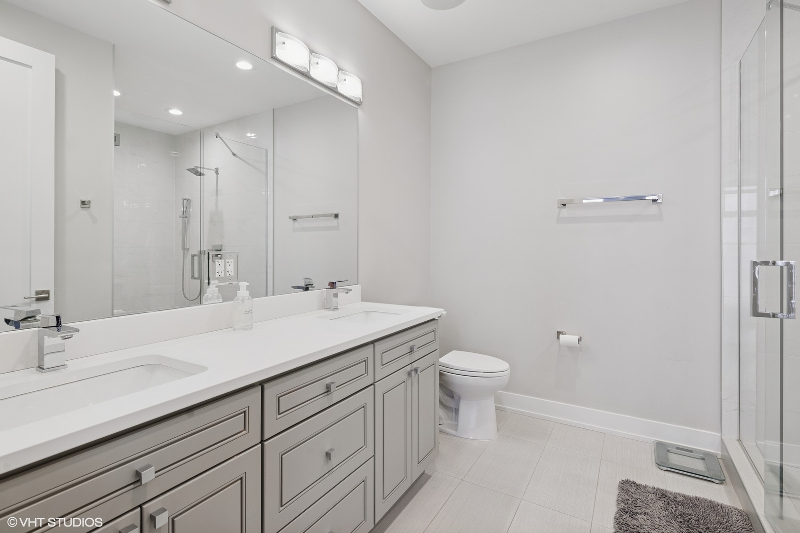 236 South Racine Avenue, Unit 304 Chicago, IL 60607 - Photo 12 of 19 a bathroom with a sink a toilet a shower and a mirror