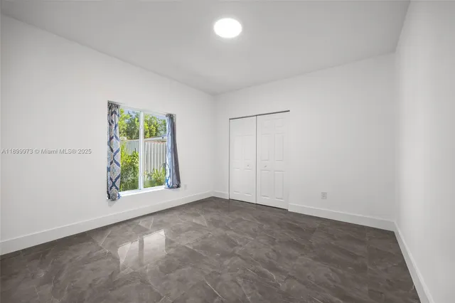 an empty room with windows and garden