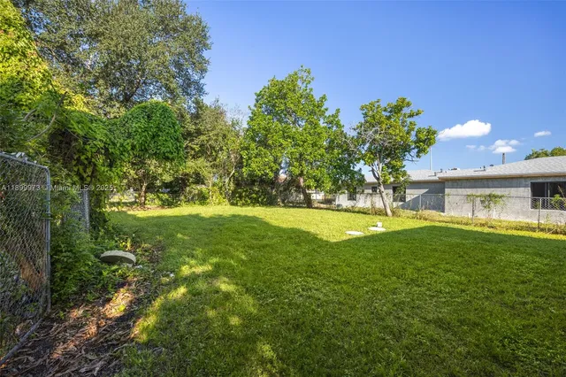 a view of house with a yard