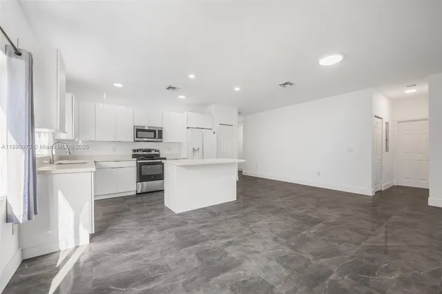a view of kitchen with wooden cabinet