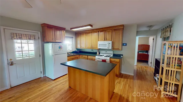 a kitchen with stainless steel appliances granite countertop sink stove top oven and cabinets