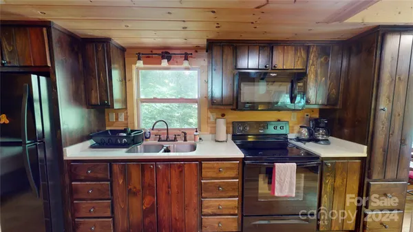 a kitchen with a sink stove and refrigerator