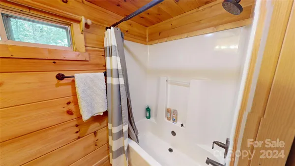 a bathroom with a bathtub and a shower