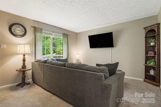 a living room with furniture and stairs
