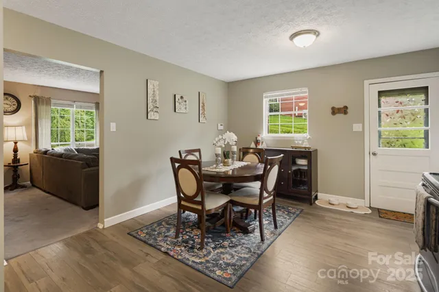a view of a dining room with furniture and a refrigerator