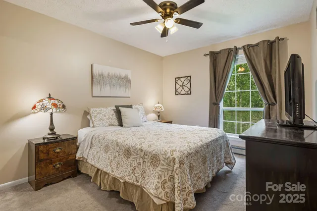 a bedroom with a bed and a chandelier