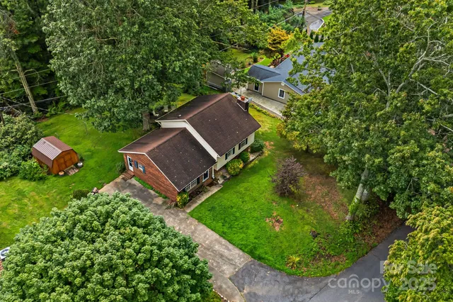 an aerial view of a house with garden space and street view