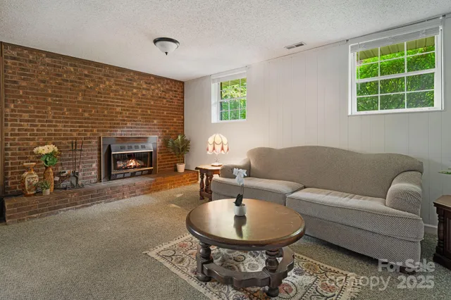 a living room with furniture a window and a table