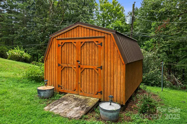 a view of a small house with garden